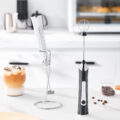 electric-milk-frother-coffee-use.webp Electric Milk Frother Making Coffee Foam